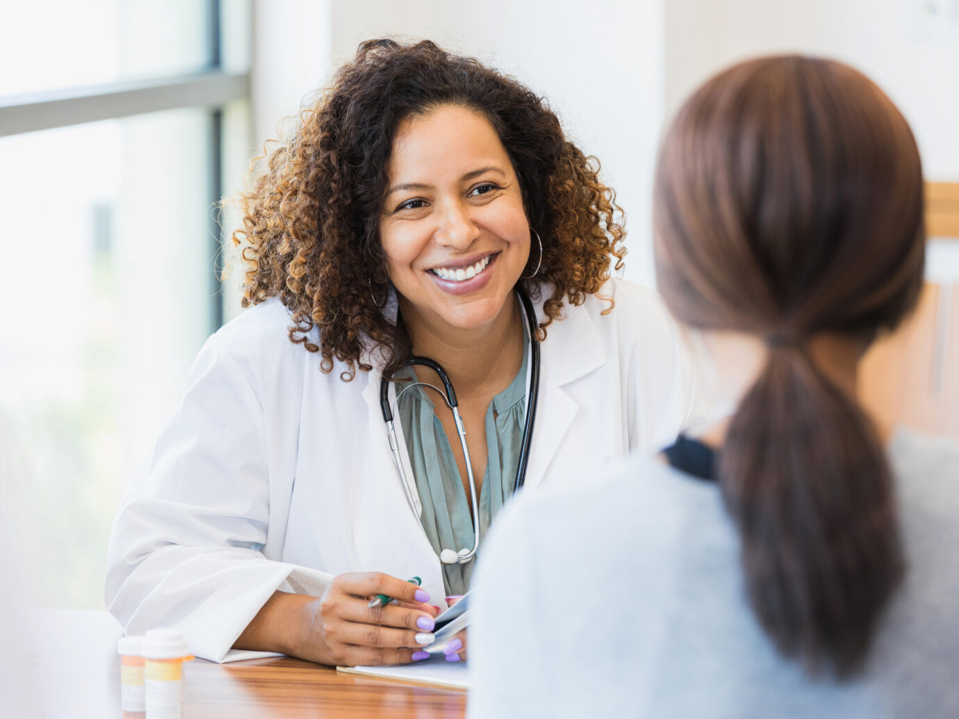 Doctor listening to her patient